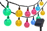 Colorful string lights with a solar panel on a white background